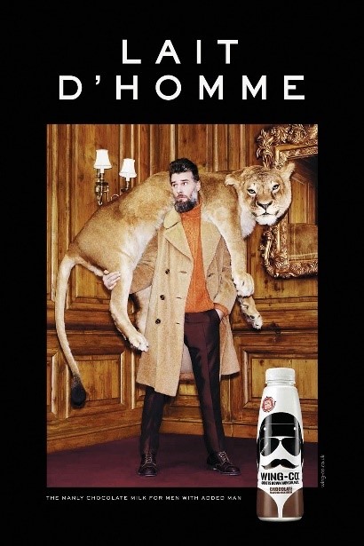 An ad for "Lait D'Homme" chocolate milk showing a man in a fur coat carrying a lion over his shoulders.