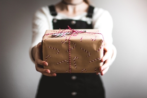 Photo of person holding wrapped gift.