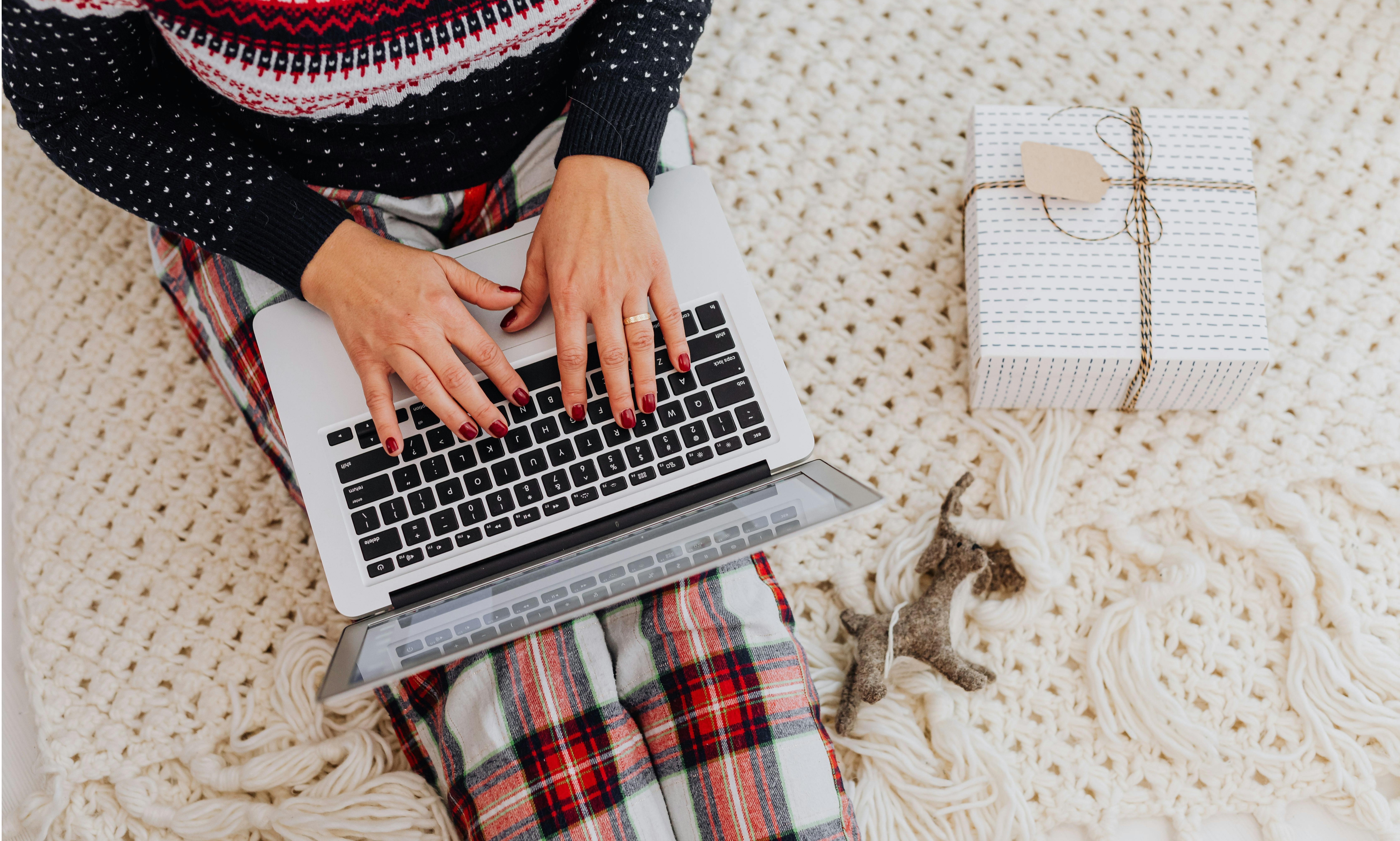 Woman on computer next to a gift