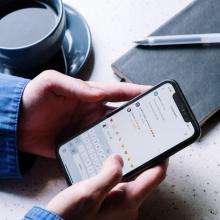 Hands holding cell phone