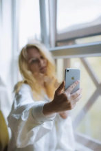 Woman taking a selfie with her cell phone.