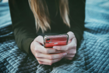 Image of a person holding a cell phone