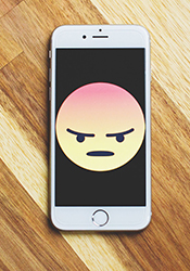 frowning emoji on cell phone